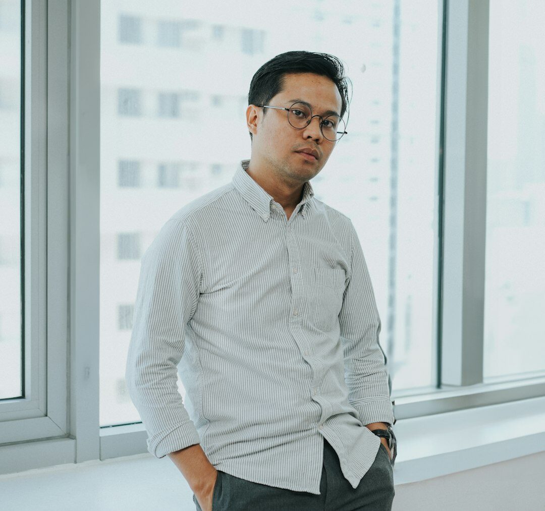 Professional portrait of a man with glasses in smart casual