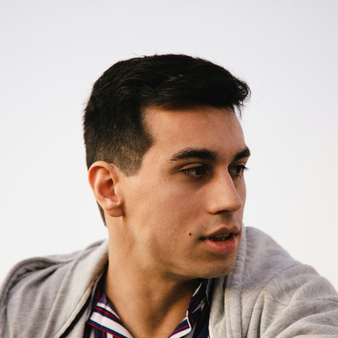 Professional portrait of a man with dark hair in business casual